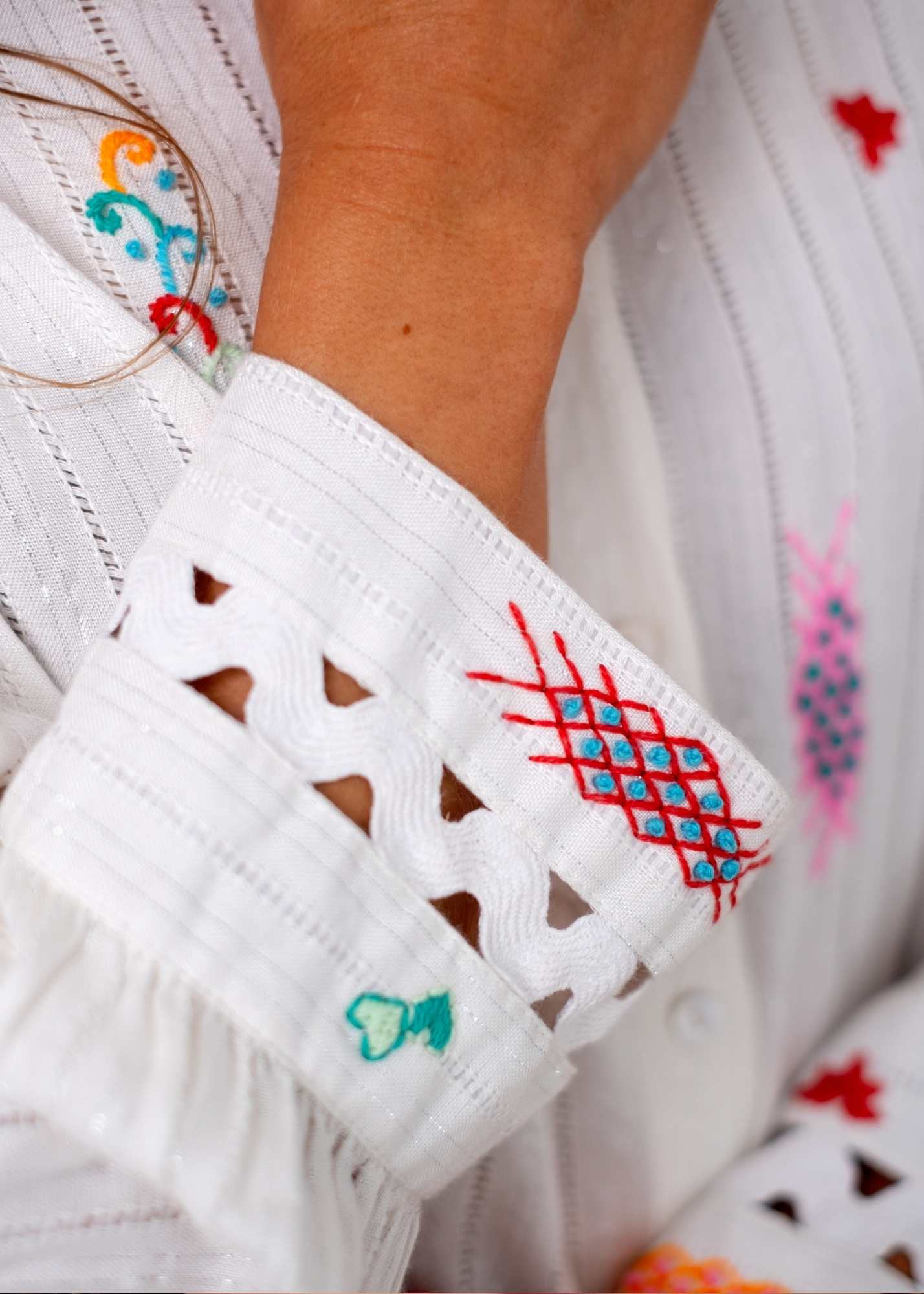 The Lily Button-Down Shirt in White with Colourful Embroidery and Cut out Cuff Detail